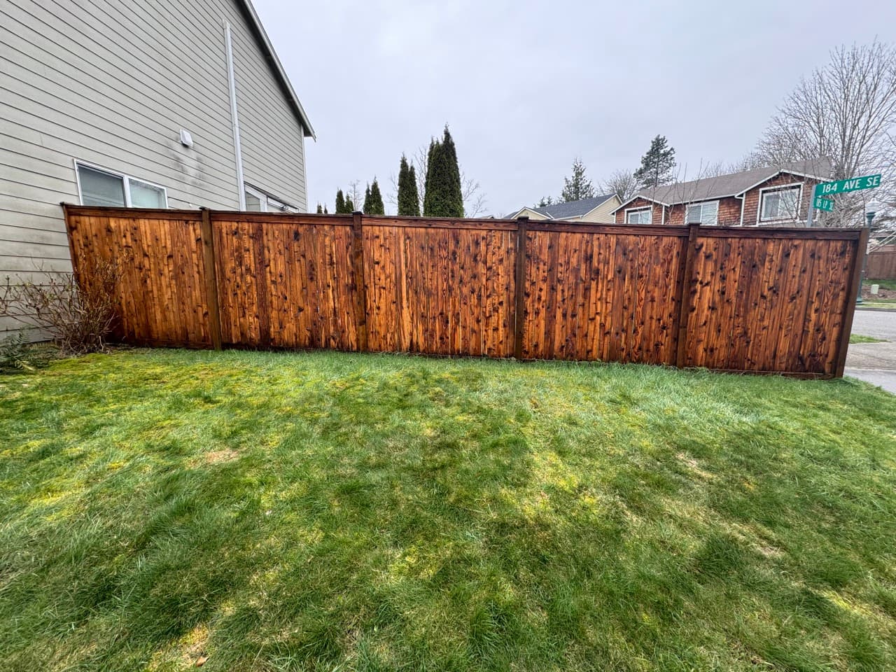 Wood fence restored to natural color after soft wash